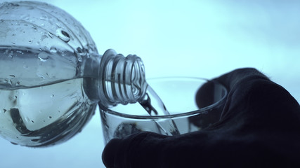 Man Pours Water From Glass