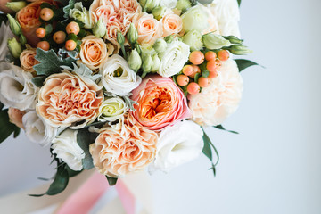 Beautiful wedding bouquet decorated with white and pink roses, bridal flowers of pastel colour