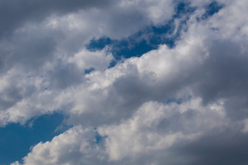 Obraz premium Slightly grey Cumulus clouds in a bright blue sky