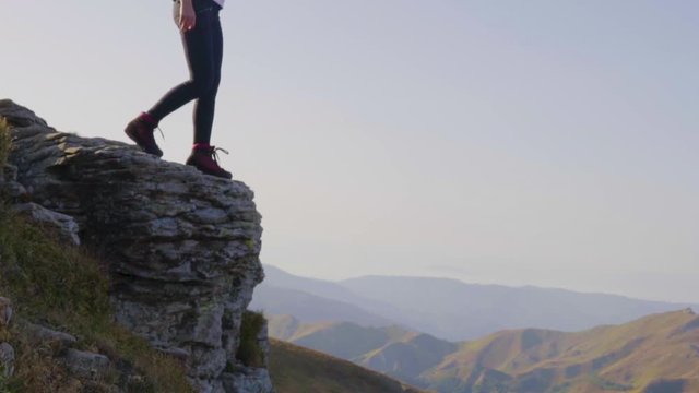 woman walking on a cliff rock mountain hiking in early morning october autumn 2018 blue sky, monte cimone mountain, modena, emilia romagna travel tourism