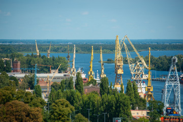 Cityscape with yellow cranes in the background