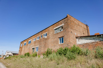 Fototapeta na wymiar old abandoned brick building with broken Windows.