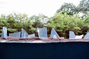 Broken sharp glass on wall