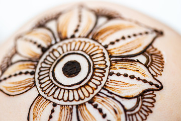 Drawing process of henna mehndi ornament on womans head