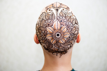 Drawing process of henna mehndi ornament on womans head