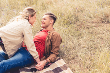 attractive woman and handsome man looking at each other