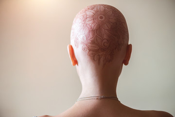 Henna mehndi tattoo on womans bald head