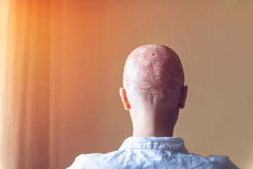 Henna mehndi tattoo on womans bald head