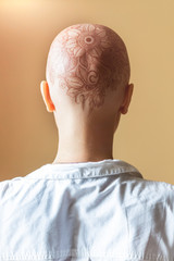 Henna mehndi tattoo on womans bald head