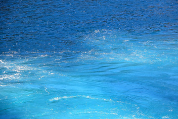 Sea surface in deep blue and turquoise tones. Selective focus.
