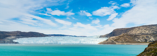 Panoramic view of glacier in Greenland. Glacier front of Eqi glacier in West Greenland AKA Ilulissat and Jakobshavn Glacier. Heavlly affected by Climate Change and Global Warming.