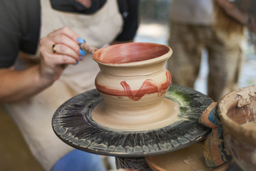 pottery craftsman hands. Clay vessel painting