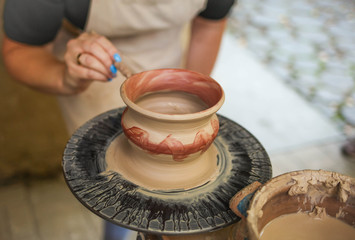pottery craftsman hands. Clay vessel painting