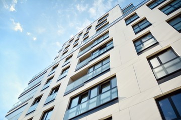 Fototapeta premium Modern and new apartment building. Multistoried modern, new and stylish living block of flats.