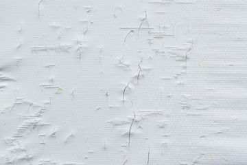 Old white canvas material with cracks and tears as a background