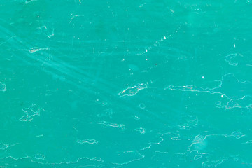 Turquoise painted wooden surface with white stains and spots as background