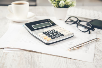 calculator on document and computer on desk