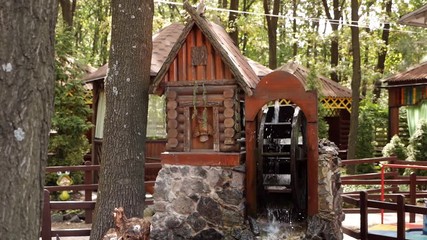 A wooden wheel produces energy using the power of water an old traditional mechanism. Wooden ring rotates with the power of water