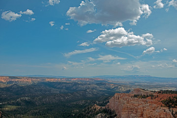 Fototapeta premium Wide view over Bryce Canyon with clouds and hoodoos on the right side