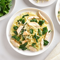 Spaghetti with spinach leaves, grilled chicken breast and cheese