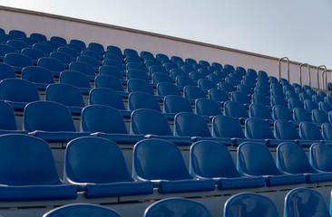 Fototapeta premium Bleachers in a sports stadium. Blue Seats In A Row