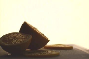 Sliced lemon on a cutting board against a light background.
