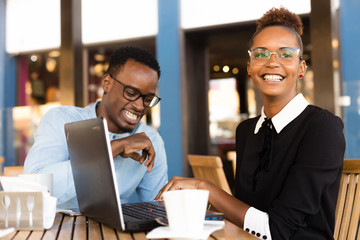 Fototapeta na wymiar Black African American coworkers doing digital teamwork arround a coffee cup