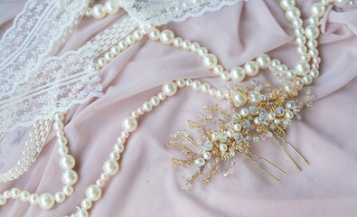 Wedding background with pearls and hair accessories on pink background