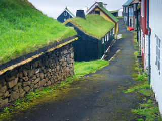 Fototapeta na wymiar street in foggy day on Faroe island village with red barrel