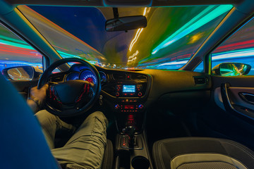 Night road view from inside car natural light street and other cars is motion blurred