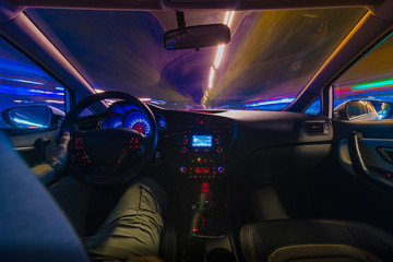 Night road view from inside car natural light street and other cars is motion blurred