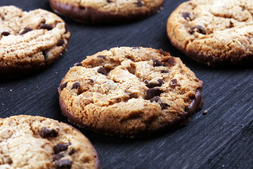 Chocolate cookies on wooden table. Chocolate chip cookies shot on table