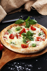 vegetarian italian Pizza with tomatoes, mozzarella cheese  and basil. Delicious italian pizza