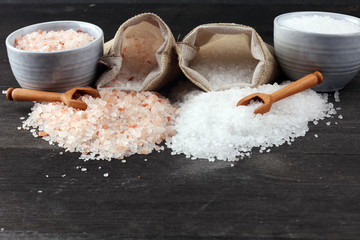 Sea salt and himalayan in burlap. Crystals of salt on dark background