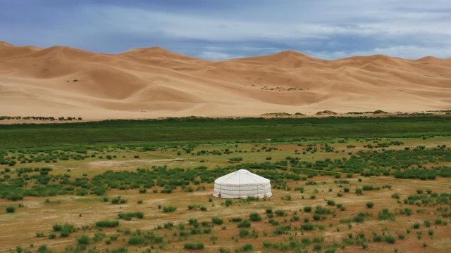 Aerial around view on lonely yurt near the sand dunes in the Gobi Desert, Mongolia