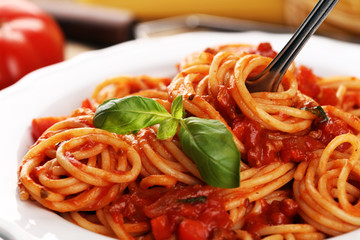 Plate of delicious spaghetti Bolognaise or Bolognese with savory minced beef and tomato sauce garnished with parmesan