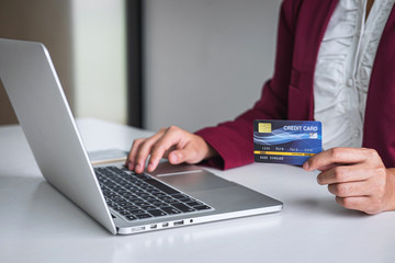 Business woman consumer holding credit card and typing on laptop for online shopping and payment make a purchase on the Internet, Online payment, networking and buy product technology