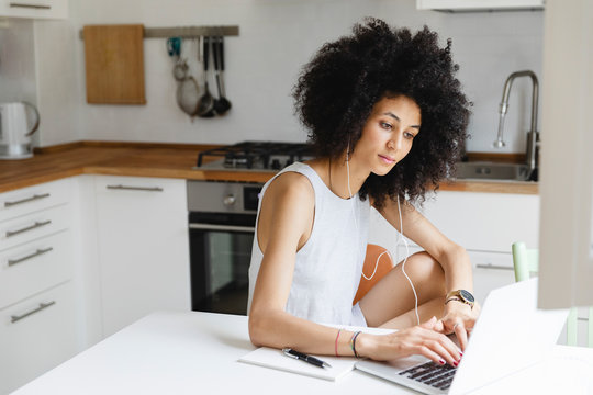 Young woman doing an online course on laptop