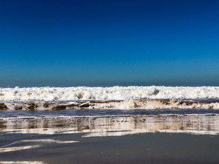 Waves breaking on sand beach