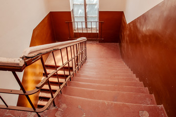A staircase with a railing leads down. Flight of stairs. Stone staircase with steps.