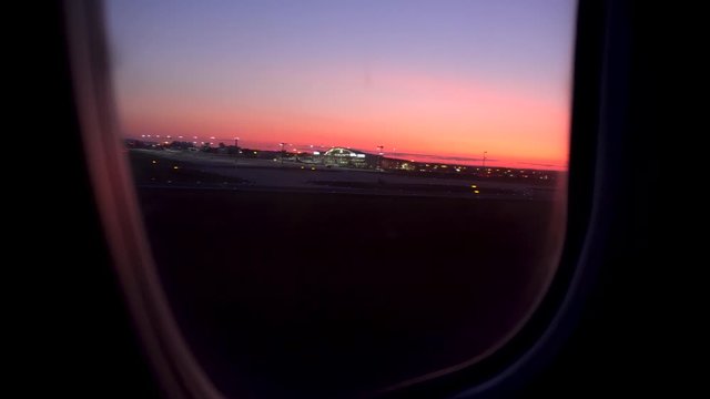The plane takes off at sunset. View from the airplane window