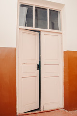 Large white high the door ajar