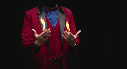 Magician shows trick with fire burn from palms hands © Parilov