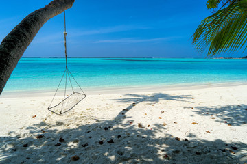 Lounge chairs on a beautiful tropical beach at Maldives