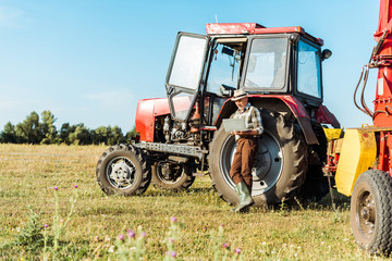 selective focus of bearded farmer in straw hat using laptop near tractor © LIGHTFIELD STUDIOS
