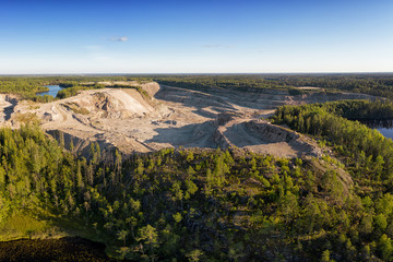 Large granite quarry in the woodland aerial view