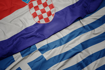 Fototapeta na wymiar waving colorful flag of greece and national flag of croatia.