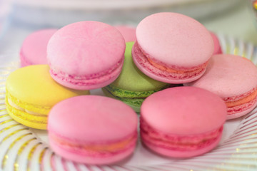 Fototapeta na wymiar pink air macaroons are on the plate.Sweet pastries