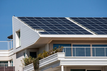 Fototapeta premium Solar panels on the roof of a modern building - photography
