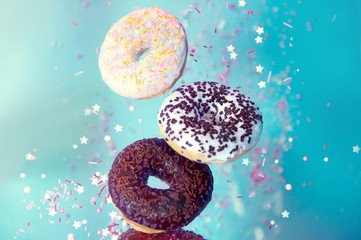 Various decorated doughnuts in motion falling Sweet and colourful donuts